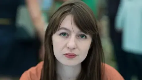 Sally Rooney claims she is unable to enter the UK due to arrest fears